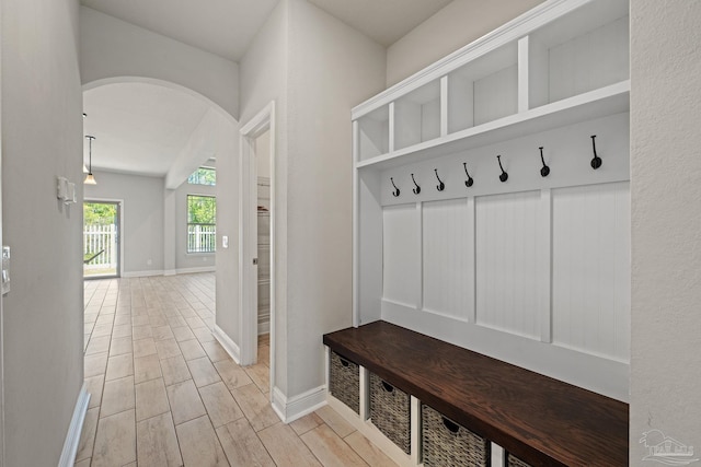 12789 Island Spirit Dr, Pensacola, FL 32506 - mudroom with light wood finished floors, baseboards, and arched walkways