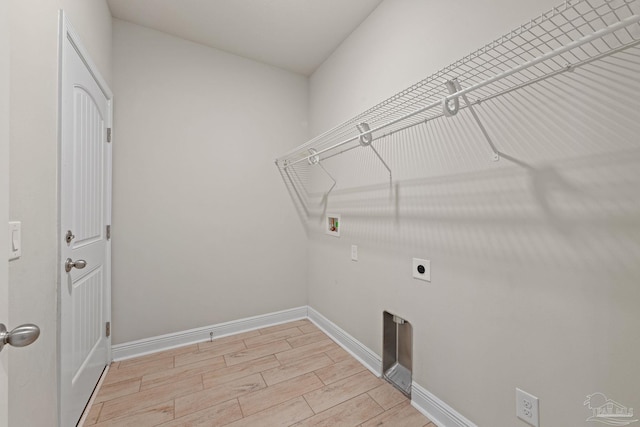 12789 Island Spirit Dr, Pensacola, FL 32506 - laundry area with hookup for a washing machine, hookup for an electric dryer, light wood-style flooring, baseboards, and laundry area