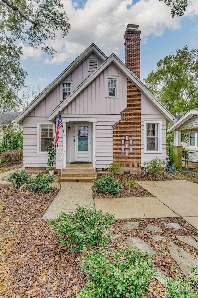 view of front of property featuring a chimney and board and batten siding