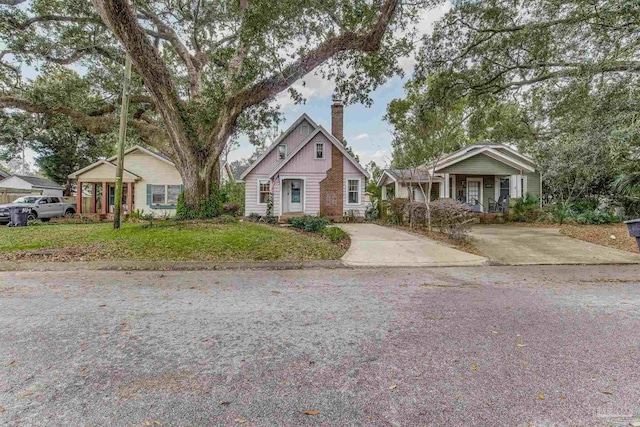 view of front of house featuring a front lawn and a chimney