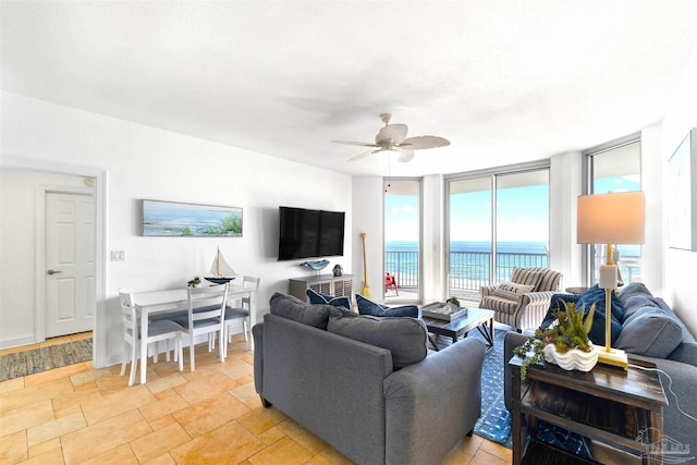 living room with expansive windows and ceiling fan