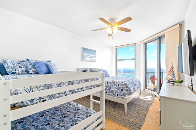 tiled bedroom featuring access to outside, floor to ceiling windows, and ceiling fan