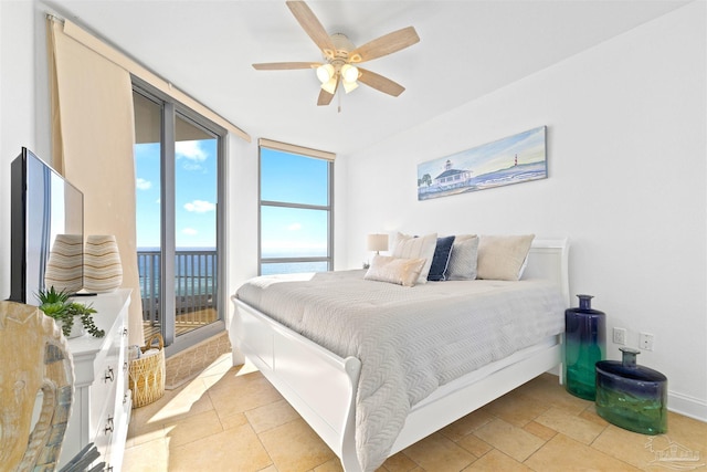 bedroom with ceiling fan, a wall of windows, and access to outside