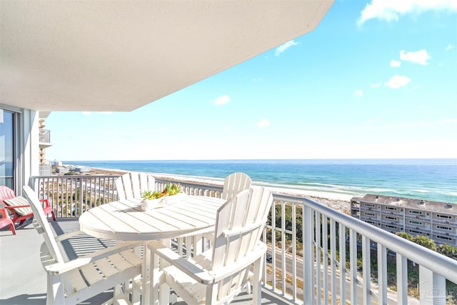 balcony featuring a beach view and a water view