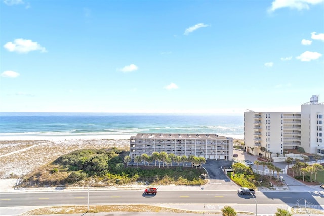 drone / aerial view featuring a water view and a view of the beach