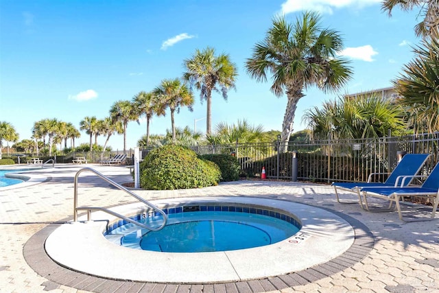 view of swimming pool featuring a hot tub