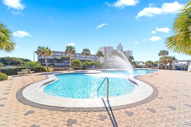 view of swimming pool with pool water feature