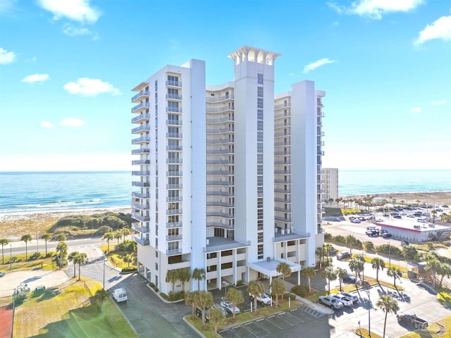 view of building exterior with a view of the beach and a water view