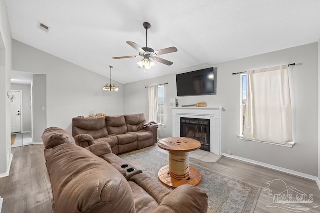 4546 Northpointe Pl, Pensacola, FL 32514 - living area featuring a ceiling fan, lofted ceiling, light wood-type flooring, a tiled fireplace, and baseboards