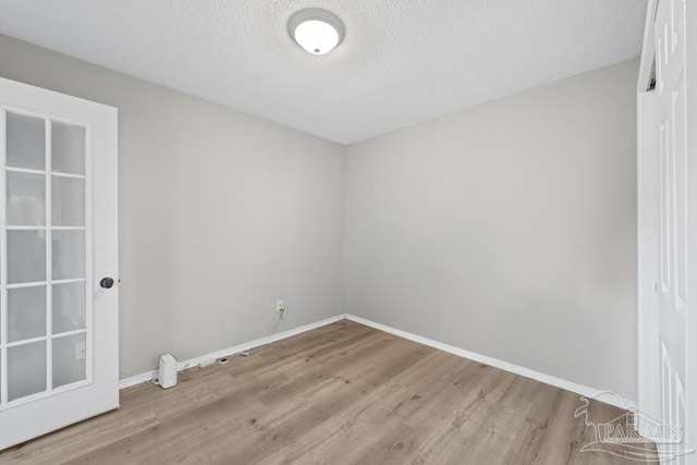4546 Northpointe Pl, Pensacola, FL 32514 - unfurnished room featuring wood finished floors, baseboards, and a textured ceiling