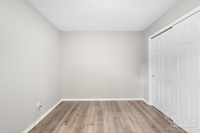 4546 Northpointe Pl, Pensacola, FL 32514 - unfurnished bedroom with light wood finished floors, baseboards, and a textured ceiling