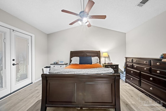 4546 Northpointe Pl, Pensacola, FL 32514 - bedroom with light wood-type flooring, vaulted ceiling, a ceiling fan, and a textured ceiling
