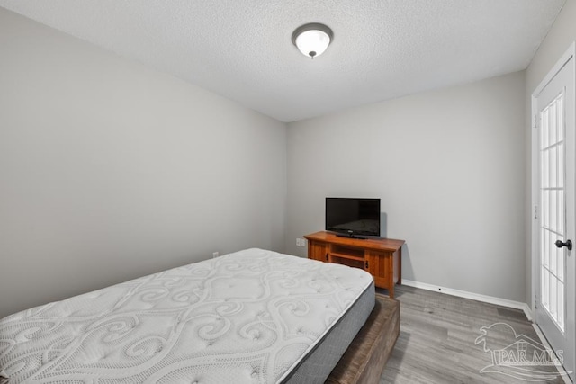 4546 Northpointe Pl, Pensacola, FL 32514 - bedroom with wood finished floors, a textured ceiling, and baseboards
