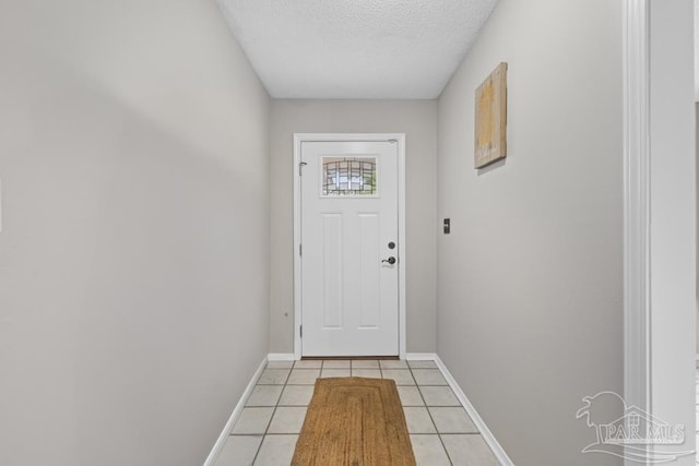 4546 Northpointe Pl, Pensacola, FL 32514 - doorway to outside with a textured ceiling, light tile patterned floors, and baseboards