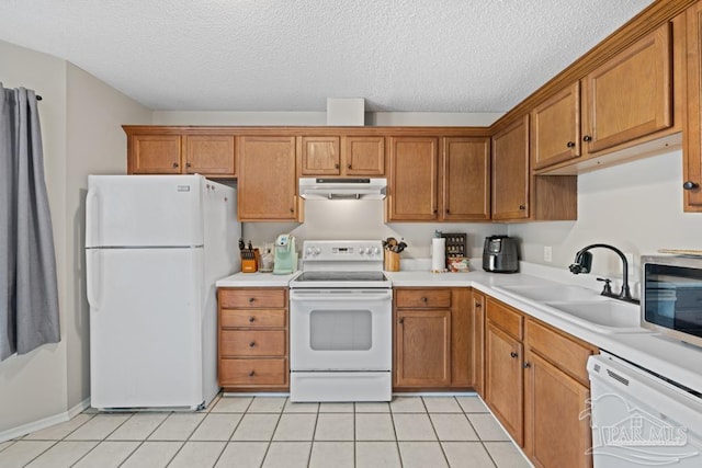4546 Northpointe Pl, Pensacola, FL 32514 - kitchen featuring white appliances, under cabinet range hood, a sink, brown cabinets, and light countertops
