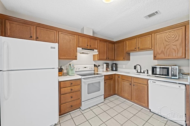 4546 Northpointe Pl, Pensacola, FL 32514 - kitchen with white appliances, a sink, under cabinet range hood, light countertops, and light tile patterned floors