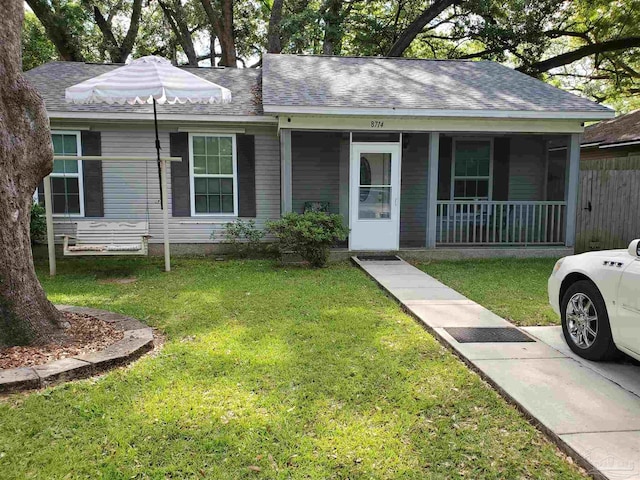 ranch-style home with a front yard and covered porch