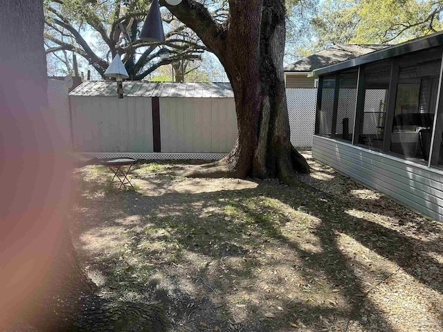 8714 Figland Ave, Pensacola, FL 32534 - view of yard featuring an outbuilding and a sunroom