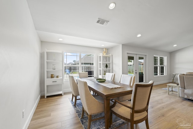 dining space featuring french doors, light wood-type flooring, recessed lighting, and baseboards