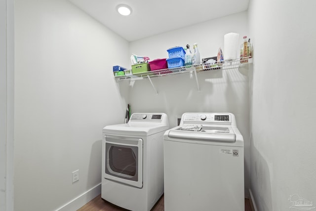 laundry area with independent washer and dryer, dark wood-style flooring, and baseboards