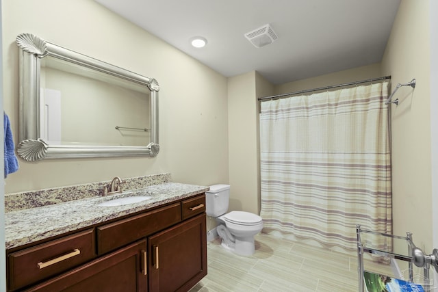 bathroom with toilet, vanity, and a shower with shower curtain