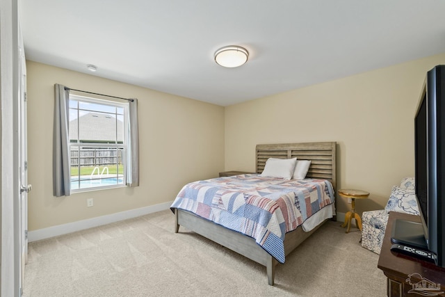 carpeted bedroom featuring baseboards