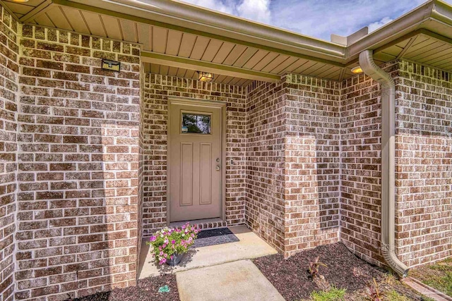 property entrance with brick siding