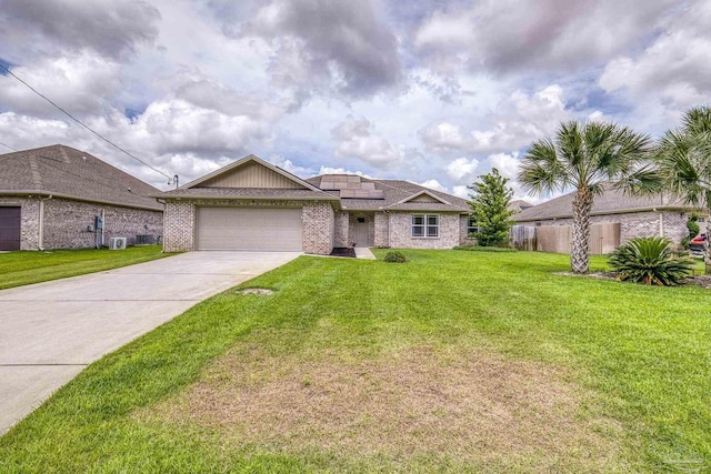 ranch-style house featuring a garage, concrete driveway, roof mounted solar panels, brick siding, and central air condition unit