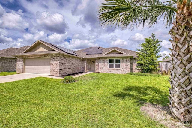 ranch-style home with a garage, roof mounted solar panels, brick siding, and concrete driveway