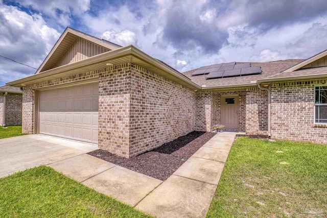 view of front of house with brick siding, board and batten siding, solar panels, a shingled roof, and driveway