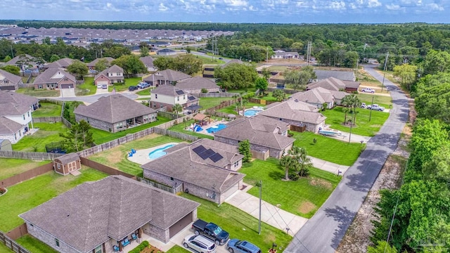 aerial perspective of suburban area featuring a pool