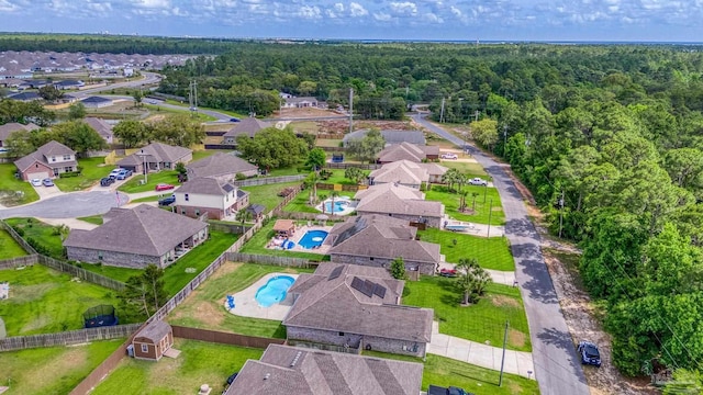 view of property location with a pool area and nearby suburban area