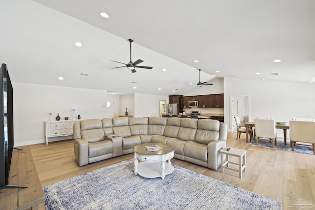 living room featuring a ceiling fan, light wood-style flooring, lofted ceiling, and recessed lighting