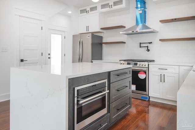 502 W Gregory St, Pensacola, FL 32502 - kitchen featuring open shelves, stainless steel appliances, wall chimney exhaust hood, dark wood-style floors, and recessed lighting
