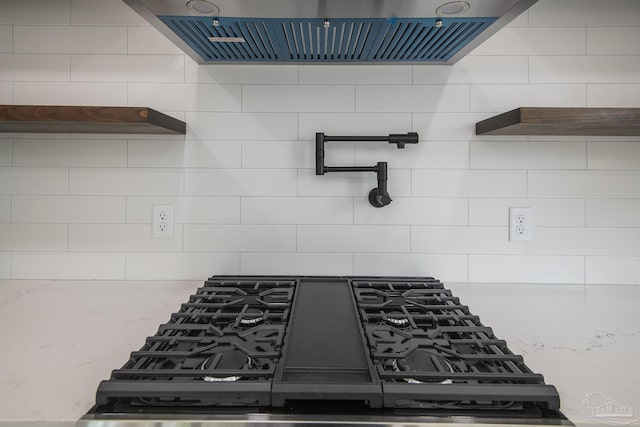 502 W Gregory St, Pensacola, FL 32502 - kitchen view of open shelves, pot filler, tasteful backsplash, ventilation hood, and light stone counters