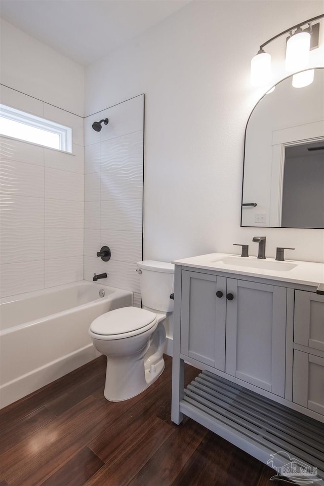 502 W Gregory St, Pensacola, FL 32502 - bathroom featuring toilet, wood finished floors, vanity, and shower / washtub combination