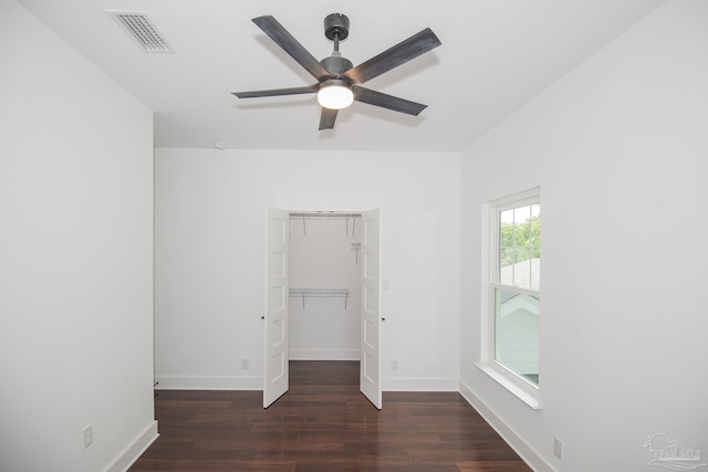 502 W Gregory St, Pensacola, FL 32502 - unfurnished bedroom featuring wood finished floors, baseboards, a spacious closet, and ceiling fan