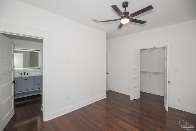 502 W Gregory St, Pensacola, FL 32502 - unfurnished bedroom featuring dark wood-type flooring, baseboards, a closet, and a sink