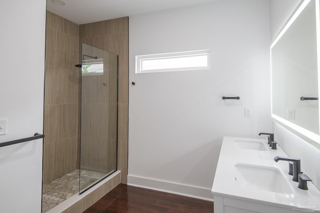 502 W Gregory St, Pensacola, FL 32502 - full bath with tiled shower, wood finished floors, baseboards, and double vanity