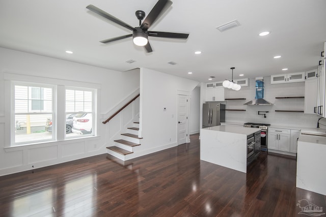 502 W Gregory St, Pensacola, FL 32502 - kitchen with appliances with stainless steel finishes, wall chimney range hood, a center island, ceiling fan, and tasteful backsplash