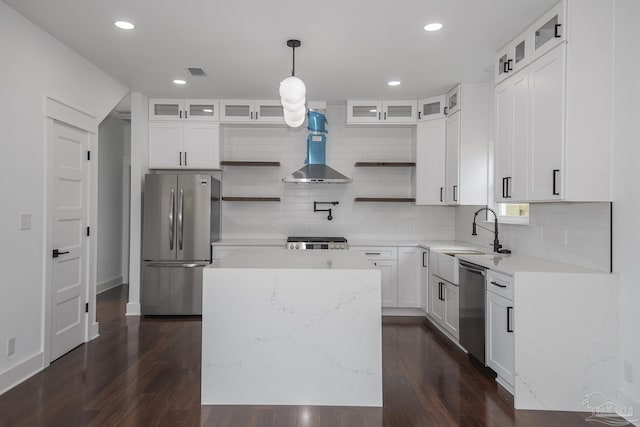 502 W Gregory St, Pensacola, FL 32502 - kitchen featuring stainless steel appliances, wall chimney exhaust hood, open shelves, a sink, and backsplash