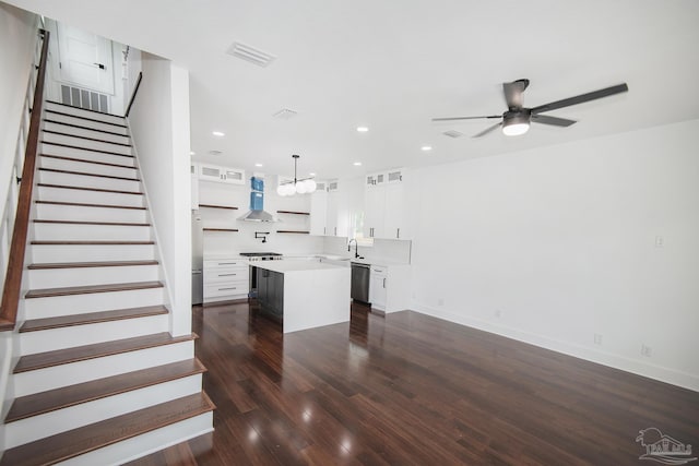502 W Gregory St, Pensacola, FL 32502 - kitchen featuring light countertops, a center island, stainless steel dishwasher, ceiling fan, and dark wood-type flooring
