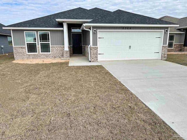 view of front of house featuring a garage and a front yard