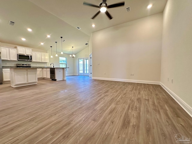 unfurnished living room featuring ceiling fan, light hardwood / wood-style flooring, sink, and high vaulted ceiling