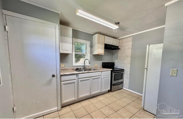 kitchen with white refrigerator, sink, white cabinets, light tile patterned floors, and stainless steel electric range