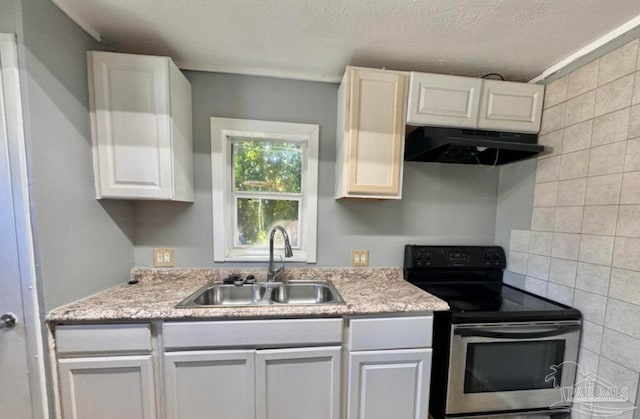 kitchen featuring sink, a textured ceiling, backsplash, white cabinetry, and electric stove