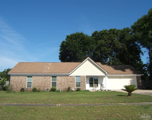 ranch-style house featuring a garage and a front lawn