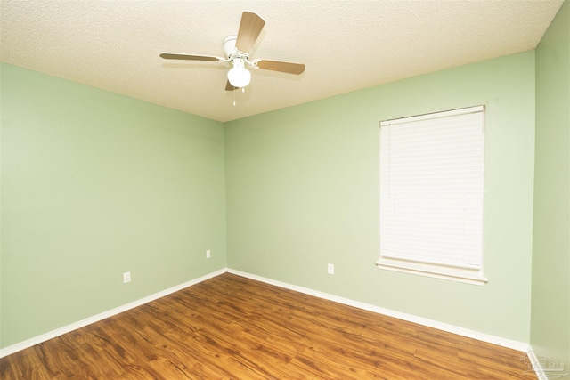 unfurnished room featuring ceiling fan, wood-type flooring, and a textured ceiling