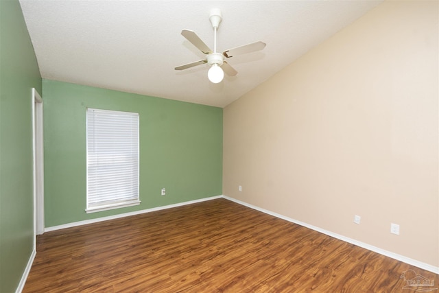 unfurnished room with a textured ceiling, lofted ceiling, ceiling fan, and dark hardwood / wood-style floors