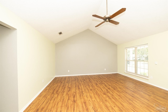 unfurnished room with ceiling fan, hardwood / wood-style flooring, and lofted ceiling